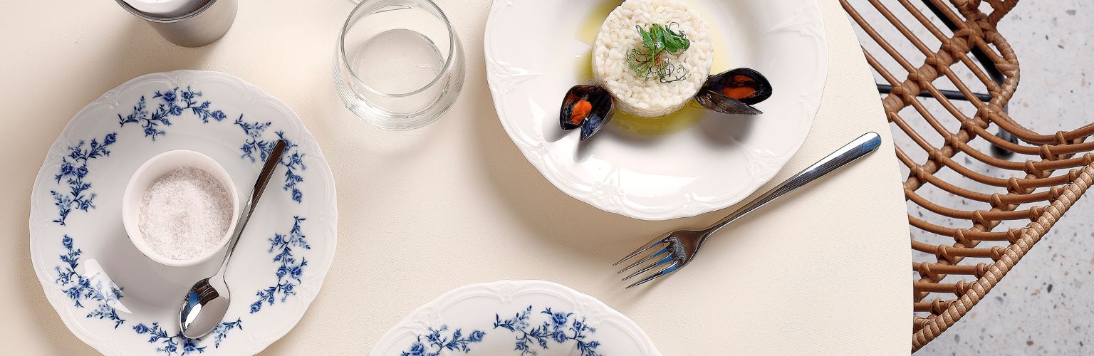 Table dressed with colorful BonBistro Retro tableware in various designs, ideal for sharing in a lively bistro setting.
