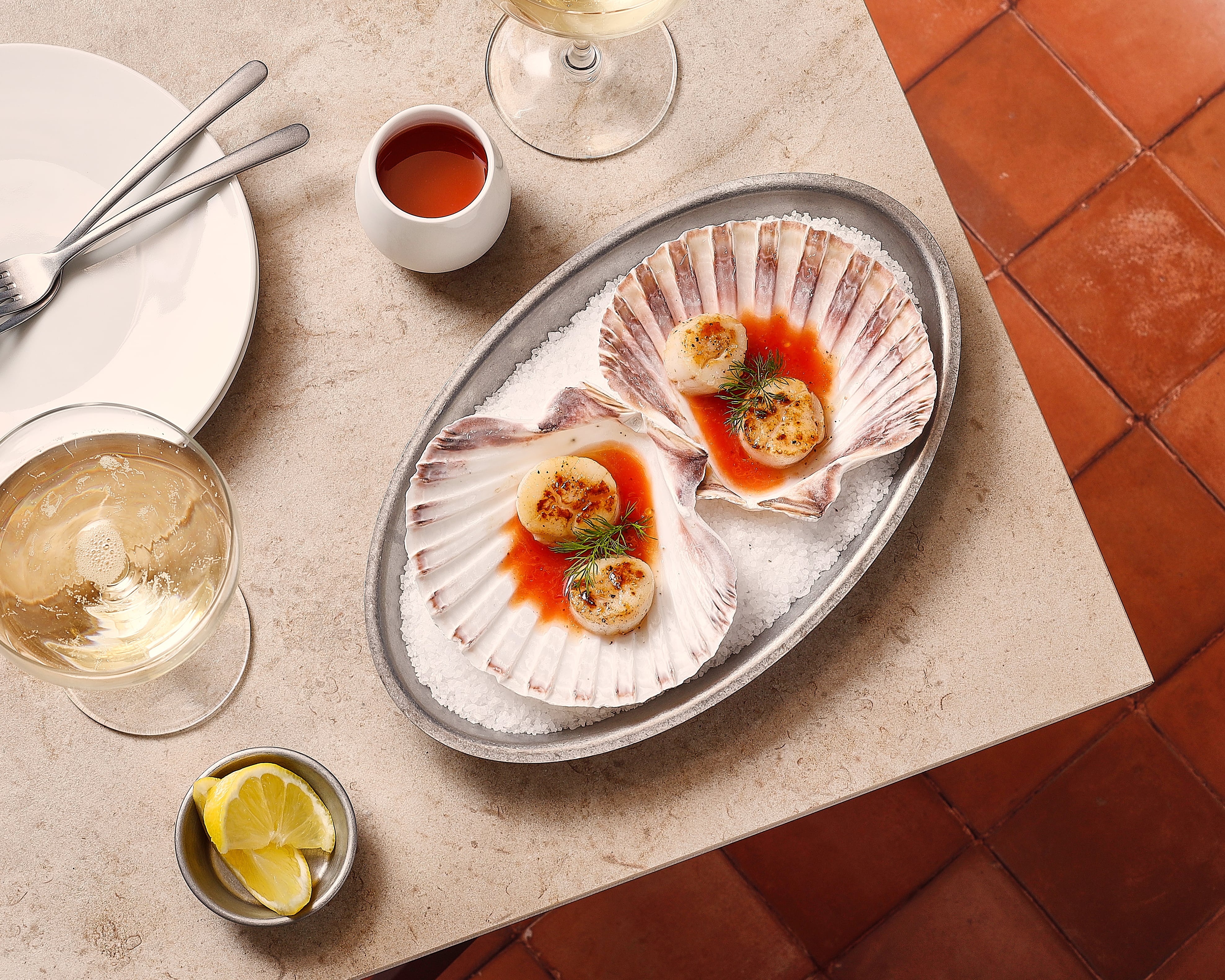 Serve collection stainless steel platter with delicate scallops, served in a sophisticated presentation.